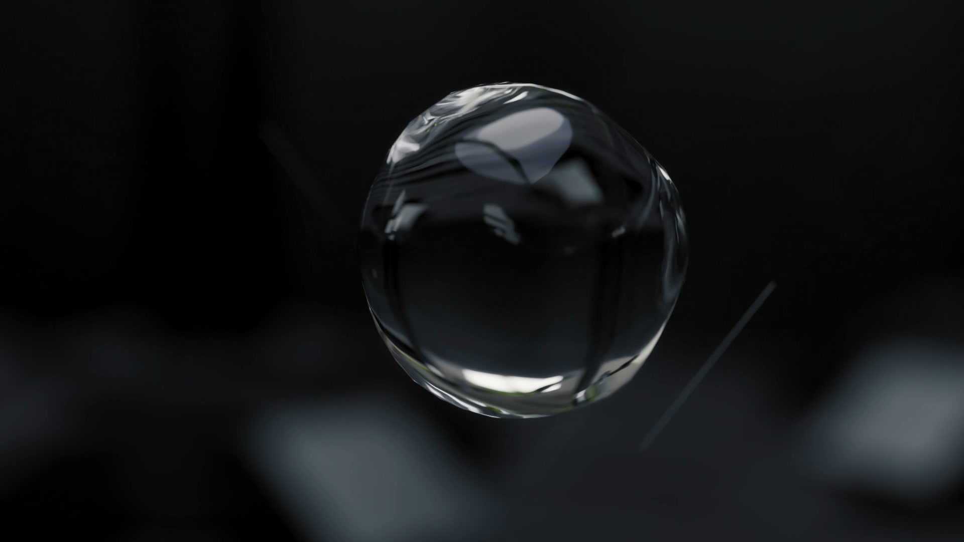 Macro shot of a single clear droplet in free fall against a dark background.