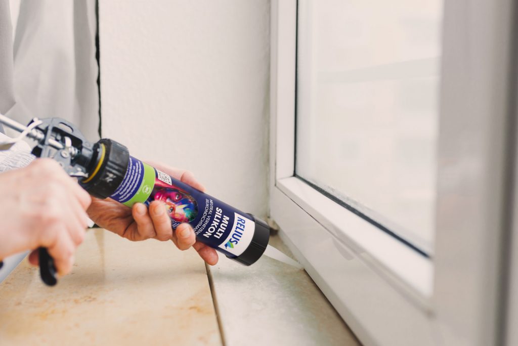 Auftrag des Relius Multi Silikons als Dichtfuge zwischen Fensterbank und Fensterrahmen, Anwendungsmotiv aus hybrider Bildproduktion